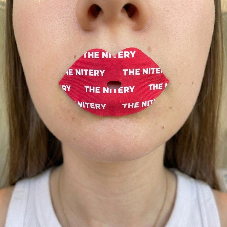 Step 2 is to place The Nitery moisturizing mouth tape on sealed, dry lips and press it down so it all sticks gently to your lips
